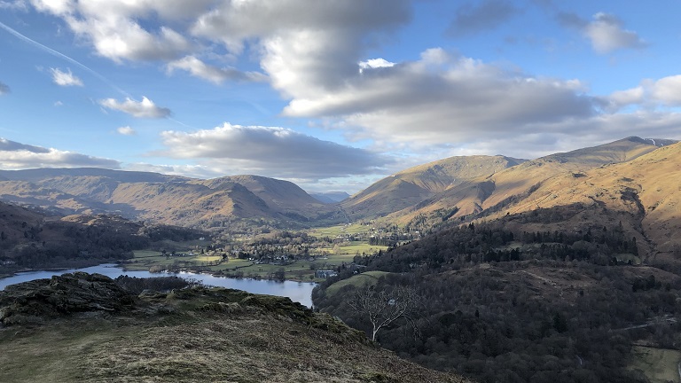 Views from Loughrigg Fell in the Lake District with a patchwork of mountains, valleys and lakes
